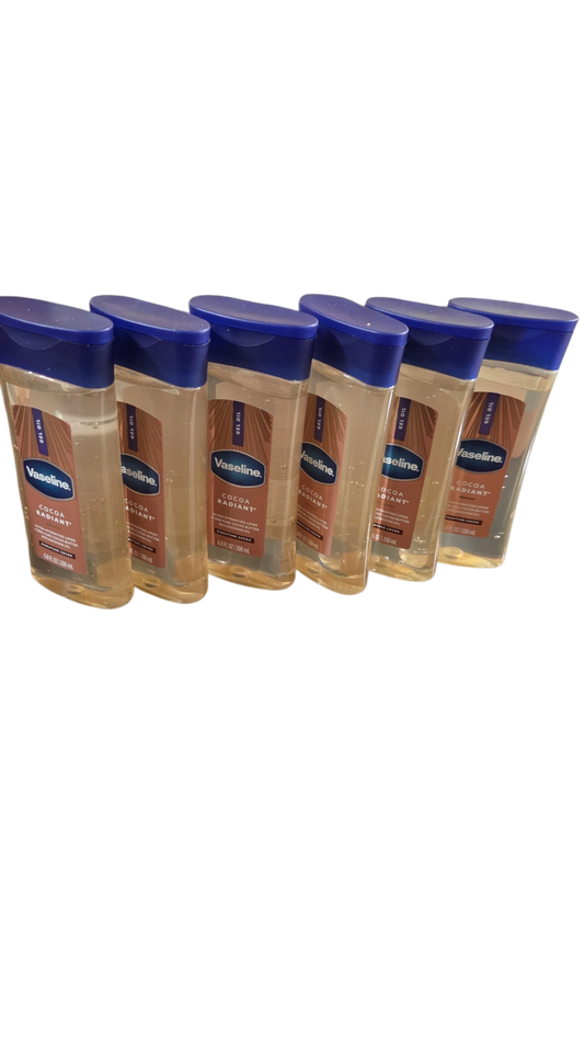 Six bottles of Vaseline lotion with blue caps on a white background